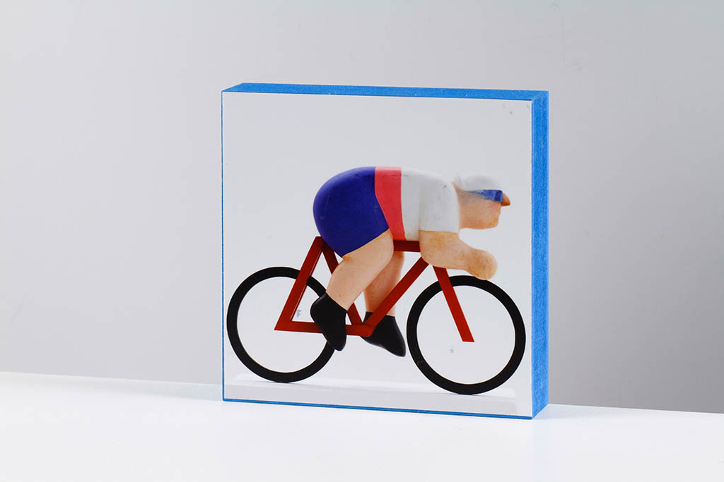 Small artwork showing a cyclist in a blue-edged frame