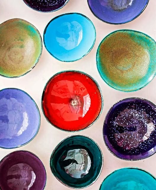 A colourful arrangement of handmade glass bowls